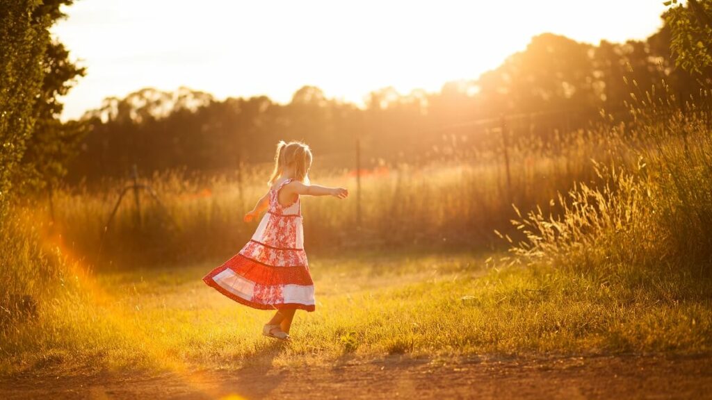 Little girl twirling in the sun