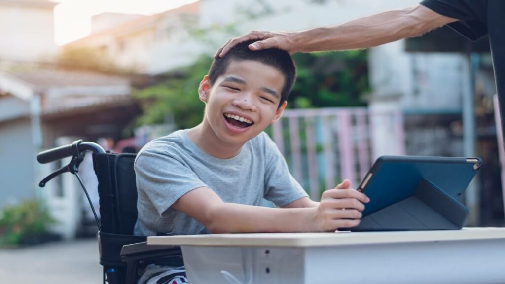 Disabled child on wheelchair happy time to use a tablet in the house, Study and Work at home for safety from covid 19, Life in the education age of special need kid, Happy disability boy concept.