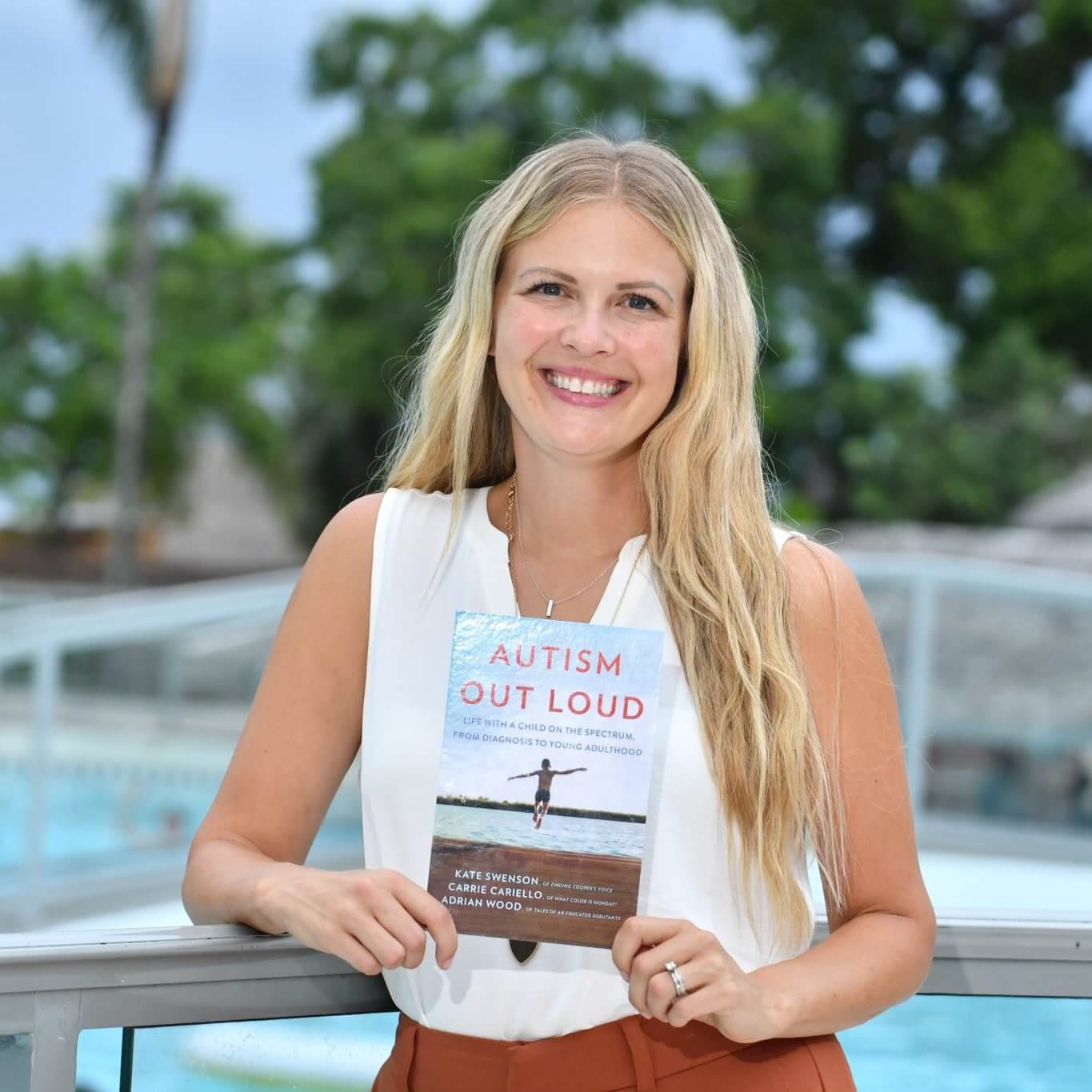 Author Kate Swenson holding Autism Out Loud book Author Kate Swenson holding Autism Out Loud book